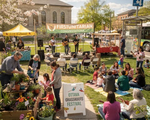 A vibrant outdoor scene at the Ottawa Grassroots Festival featuring a small stage with musicians performing for an audience seated on chairs and grass. Some individuals play guitars, while families and groups enjoy the festive atmosphere. Tents and stalls, including a plant sale, are set up around the area, alongside a sign for the First Unitarian Congregation. The event showcases a lively and community-focused gathering.